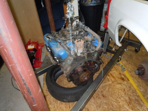 2001 Ford Crown Victoria - An engine is hoisted on an engine stand, ready for installation or repair.