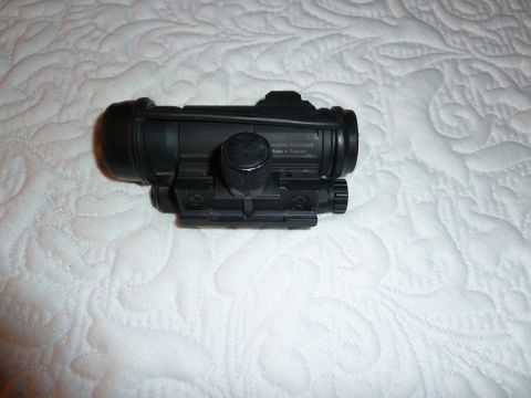 1992 Ford Mustang - A black optical sight is shown resting on a white quilted surface.