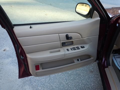 2001 Ford Crown Victoria - The interior door panel of a Ford Crown Victoria is visible, with a 'Thank You' note on the floor mat.