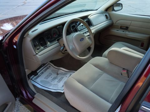 2001 Ford Crown Victoria - The interior of a maroon 2001 Ford Crown Victoria, viewed from the passenger side door.