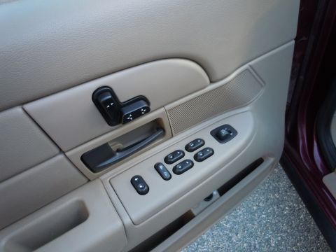 2001 Ford Crown Victoria - Car door interior with power window and seat controls visible.