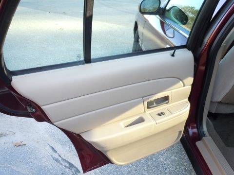 2001 Ford Crown Victoria - Interior view of a car's door panel, with another vehicle reflected in the window.