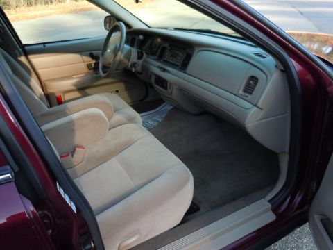 2001 Ford Crown Victoria - Interior view of a 2001 Ford Crown Victoria, showing tan seats and dashboard.