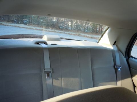 2001 Ford Crown Victoria - Rear interior view of a 2001 Ford Crown Victoria, showing the seat and seatbelts.