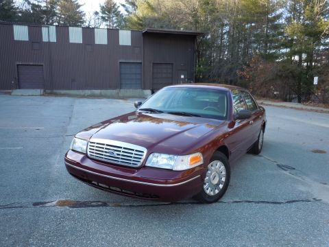2001 Ford Crown Victoria - Maroon 2001 Ford Crown Victoria is shown from a three-quarter front view in a parking lot.