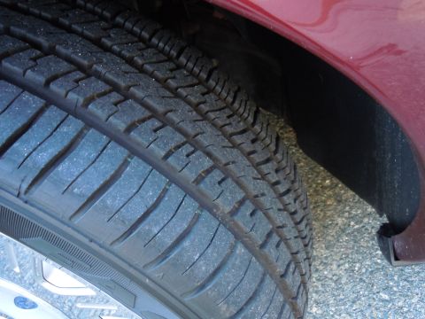 2001 Ford Crown Victoria - A close-up view of a vehicle's tire and the surrounding wheel well.