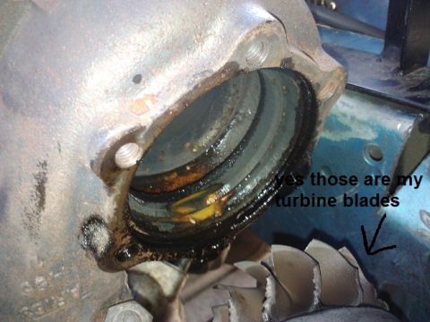 1995 Ford Probe - Damaged turbine blades are visible within a corroded metal housing, indicating a mechanical failure.