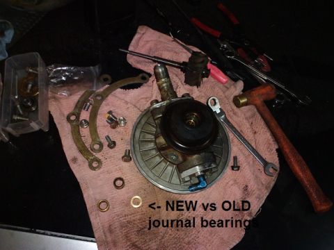 1995 Ford Probe - Comparison of a new and old journal bearing, with various tools laid out on a cloth.
