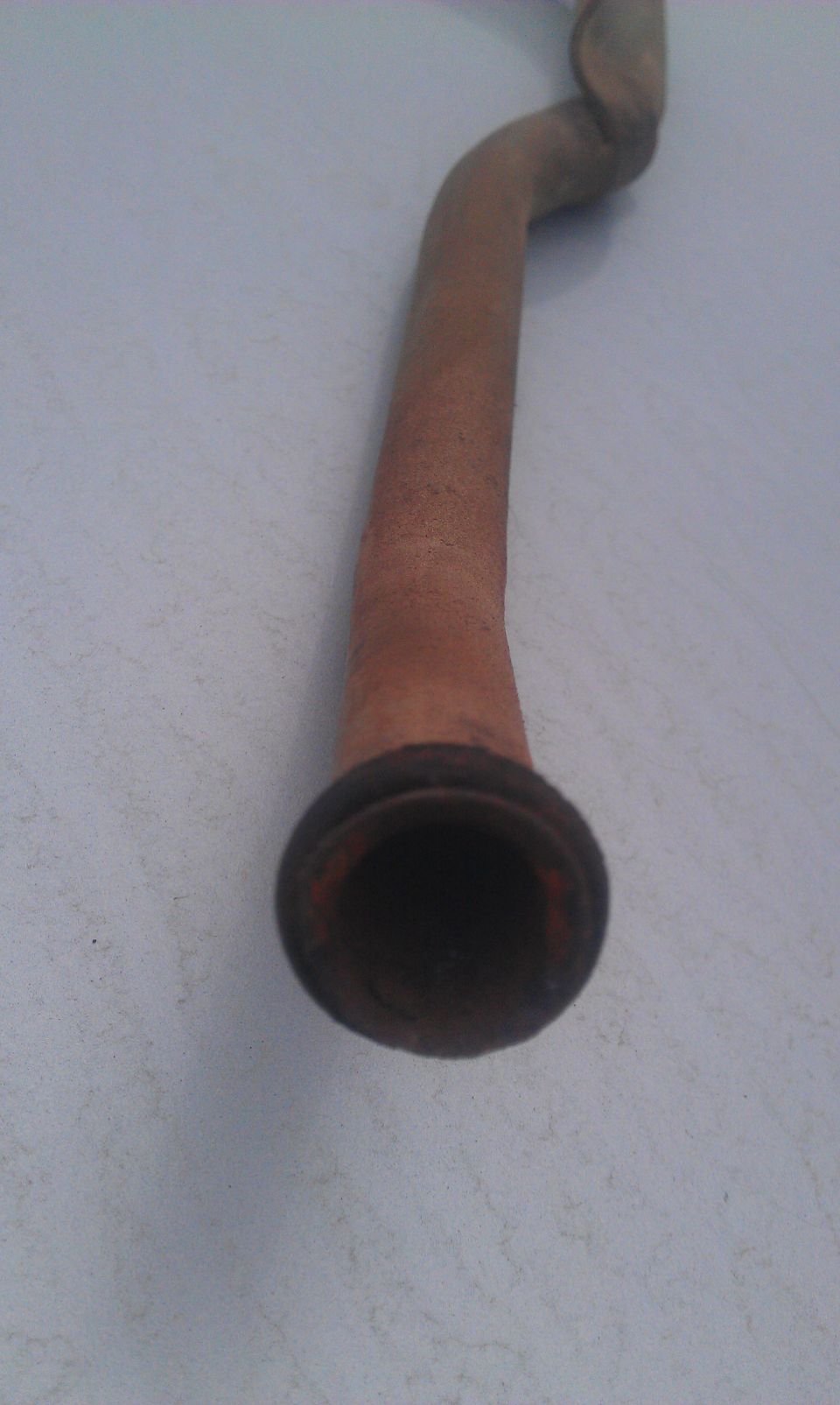 Rusty exhaust pipe with a flared end
