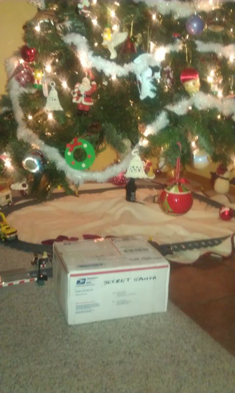 1991 Ford Festiva - A decorated Christmas tree stands over a "SECRET SANTA" package on the floor.