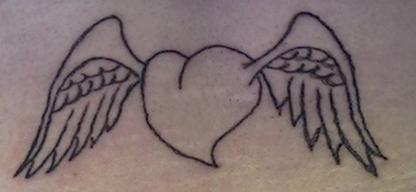 1994 Ford Crown Victoria - A tattoo of a heart with wings is visible on the skin.