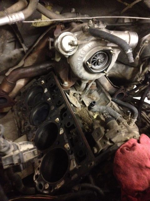 1984 Ford Bronco - Close-up of an engine block and turbocharger, showing internal engine components.