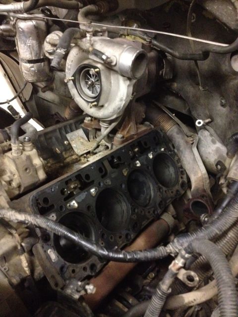 1984 Ford Bronco - Close-up view of a disassembled diesel engine, showing the turbocharger and cylinder block.