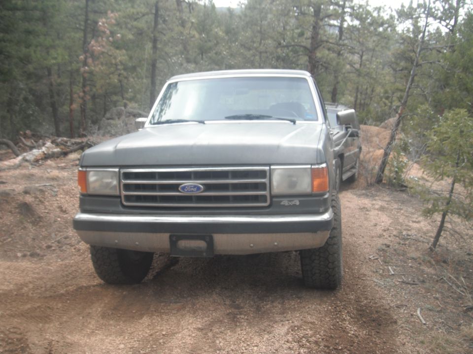 Gray Ford F-Series truck on dirt road, front view