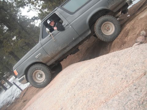 1990 Ford Bronco - Ford Bronco navigating a steep, rocky trail in Colorado.