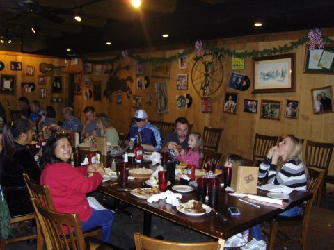 2007 Ford Mustang - Diners are seated at tables in a restaurant, with various decorations adorning the walls.