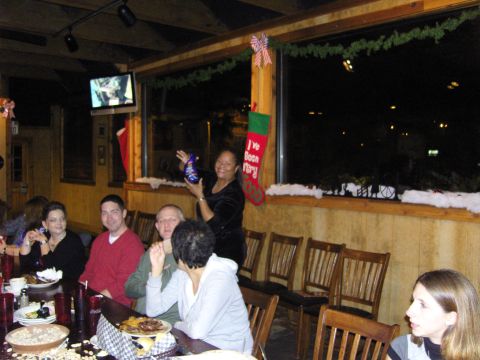2007 Ford Mustang - A group of people are gathered around a table, celebrating a holiday event with decorations visible.