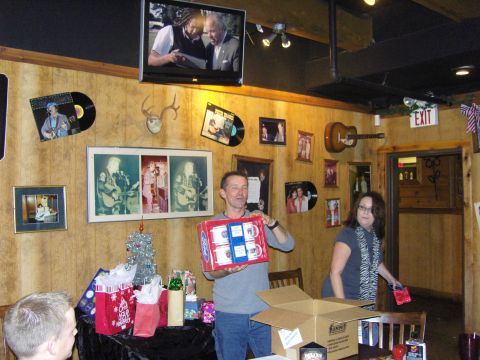 2007 Ford Mustang - A group of people are in a room with various decorations, including records and photos on the wall.