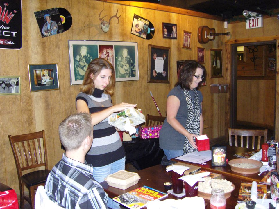People gathered around a table in a room decorated with records and photos