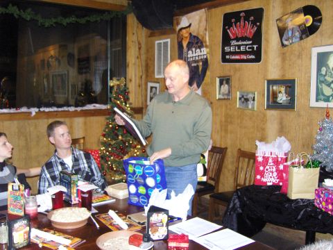 2007 Ford Mustang - A group of people are celebrating Christmas, with gifts and decorations visible around the room.