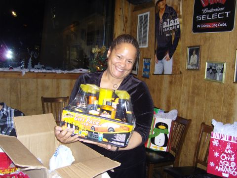 2007 Ford Mustang - A woman smiles while holding a car cleaning gift pack, likely a Christmas present.