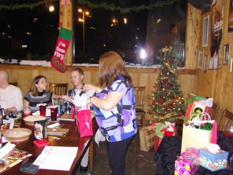 2007 Ford Mustang - A festive indoor scene with people, a Christmas tree, and holiday decorations.