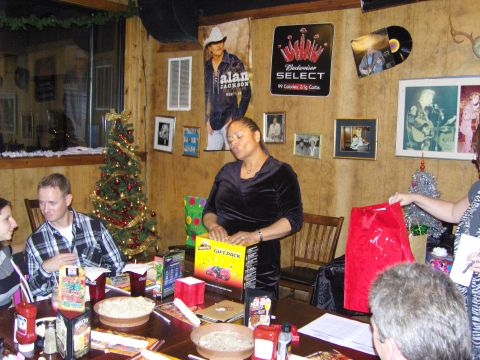 2007 Ford Mustang - A group of people are celebrating at a table during a Christmas party.