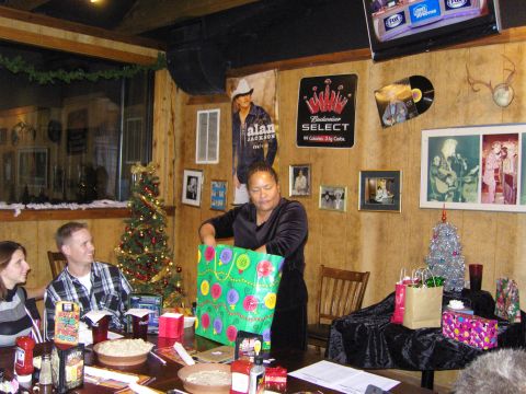 2007 Ford Mustang - A festive gathering with people opening gifts around a Christmas tree.