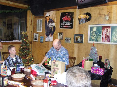 2007 Ford Mustang - A Christmas gathering with people, decorations, and posters on the wall.