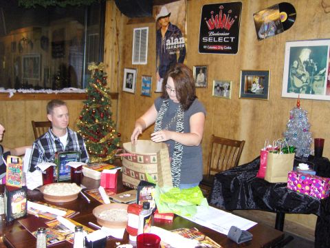 2007 Ford Mustang - A festive indoor gathering with people, gifts, and holiday decorations, including posters of musicians.