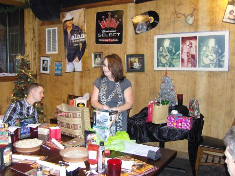 2007 Ford Mustang - A festive Christmas party is underway, with decorations, wrapped gifts, and attendees enjoying the celebration.
