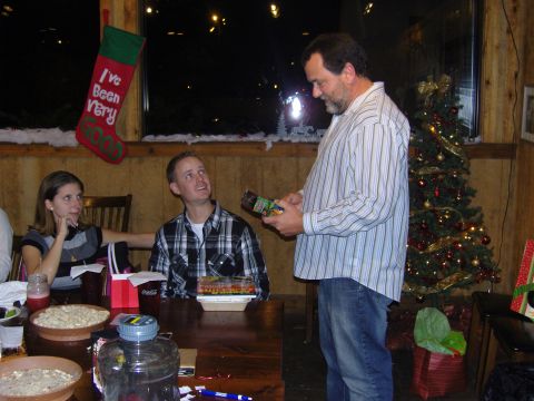 2007 Ford Mustang - A group of people are celebrating Christmas together, exchanging gifts and enjoying the festive atmosphere.