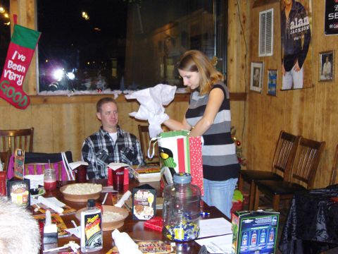 2007 Ford Mustang - A Christmas gathering with gifts being opened at a table.