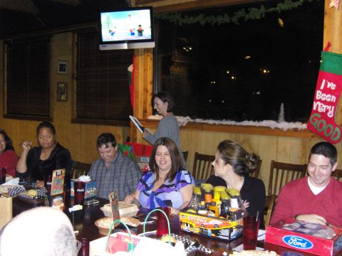 2007 Ford Mustang - A group of people are gathered around a table, enjoying a Christmas party with festive decorations.