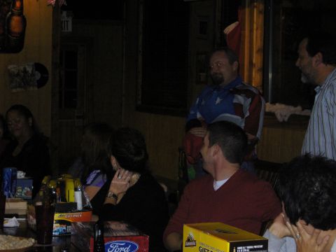 2007 Ford Mustang - A group of people are seen at a party, with gift boxes on the tables in the foreground.