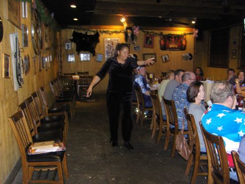 2007 Ford Mustang - A group of people are gathered for a party in a restaurant with wood-paneled walls and decorations.