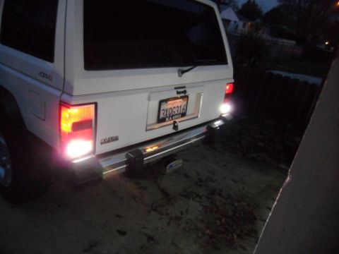 1994 Jeep Cherokee - Rear view of a white Jeep Cherokee with a chrome bumper and California license plate.