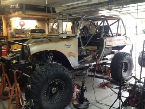 1961 International Scout 800 - A 1961 International Scout 800 is shown mid-customization, a prominent roll cage and oversized off-road tires.
