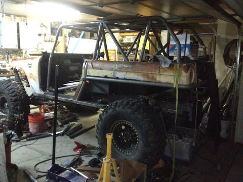 1961 International Scout 800 - This vehicle is undergoing significant modifications, including the addition of a custom roll cage and large off-road tires.