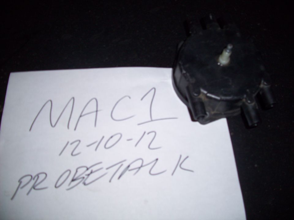 Black distributor cap with handwritten note that says MAC1 12-10-12 PROBETALK