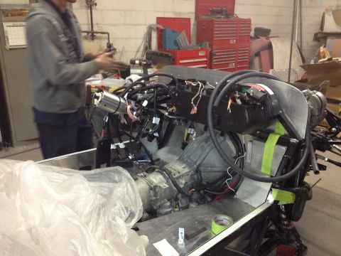 1975 Ford Ranchero - Engine and transmission assembly being worked on in a garage setting.