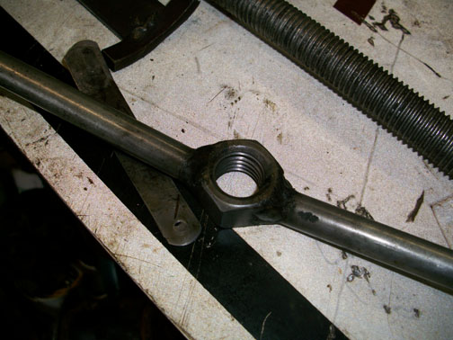 detail of the nut and bar stock twisty thing for compressing the spring to allow snap ring removal.