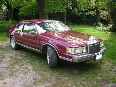 1992 Lincoln Mark VII - This Lincoln Mark VII is parked on a grassy area surrounded by trees.