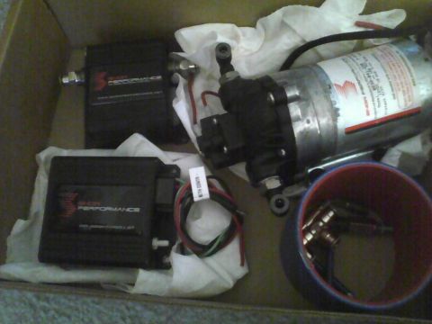 2003 Ford Crown Victoria - Several automotive performance parts, including two Bosch Performance modules and a pump, are laid out in a box.