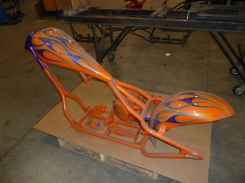 1992 Ford Mustang - Custom motorcycle frame and fender assembly with flame paintwork sits on a wooden pallet.