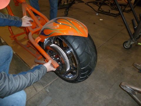 1992 Ford Mustang - Custom orange motorcycle fender with flame graphics and a wide chrome wheel is shown.