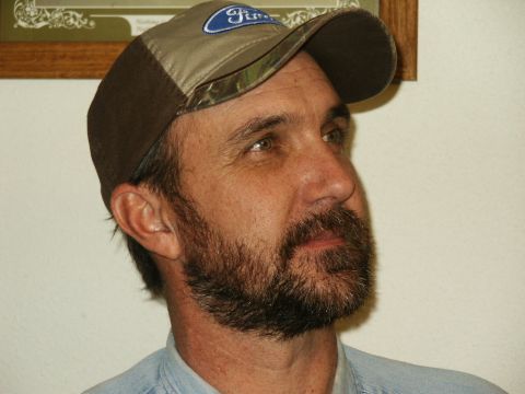 1990 Ford Bronco - A man with a beard and a Ford hat is shown in this close-up photo.