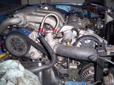 1995 Ford Probe - Close-up view of a V6 engine bay, showing the timing belt, pulleys, and various hoses.