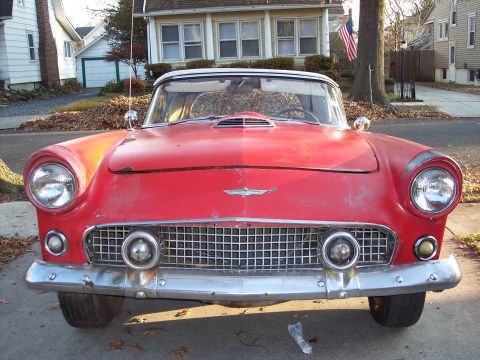 1956 Ford Thunderbird - Front view of a red 1956 Ford Thunderbird with its distinctive grille and headlights.
