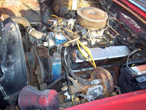 1956 Ford Thunderbird - Close-up view of a vehicle's engine bay, showing the carburetor and air cleaner assembly.